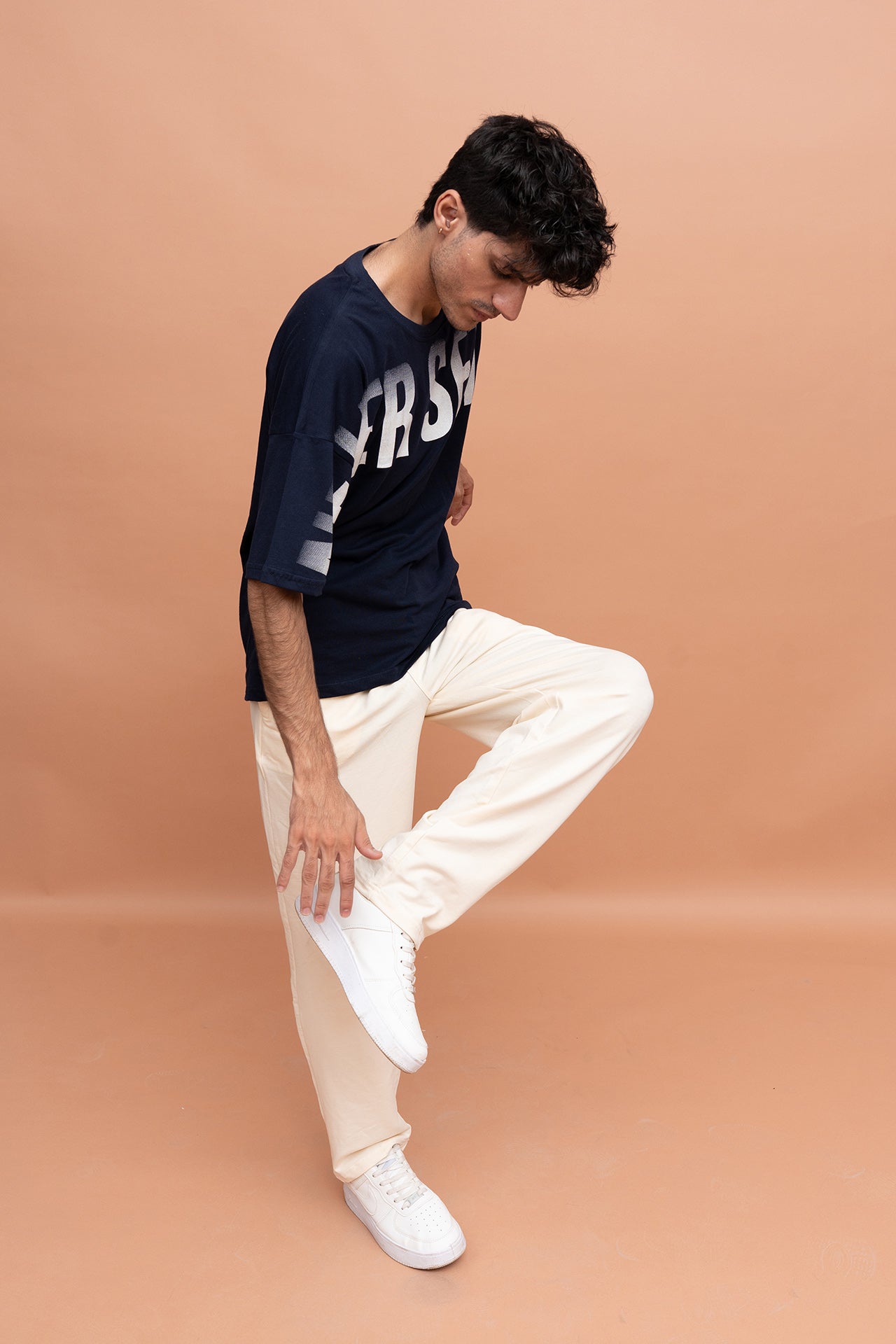 Men wearing VIVE Never Settle graphic T-shirt with stretchable cotton terry loose fit trousers in a casual streetwear style.