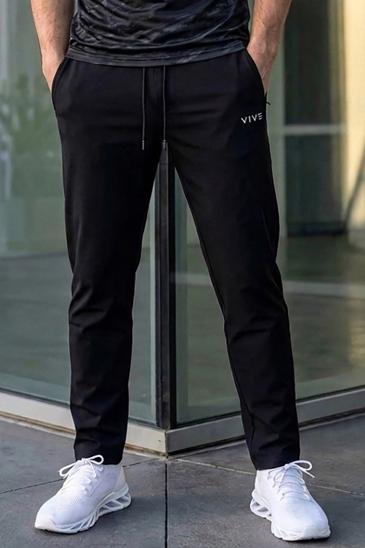 VIVE Black relaxed fit trouser featuring secure side zip pockets.